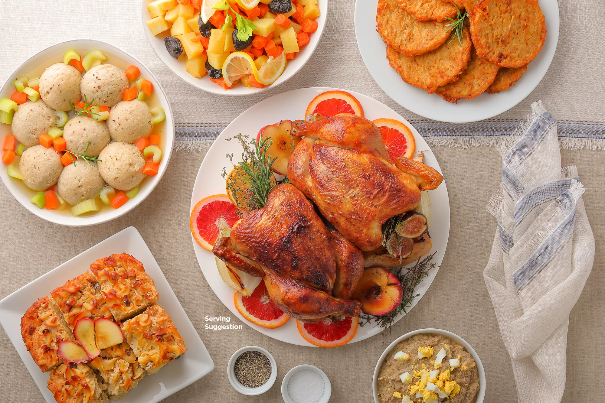 2 rotisserie chickens on white plate surrounded by side dishes